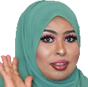 a close up of a woman wearing a green hijab and waving her hand .