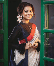 a woman is standing in front of a green door that says apila 's makeup academy