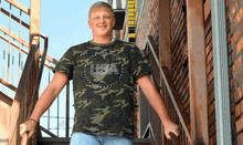 a young man is standing on a set of stairs wearing a usa shirt