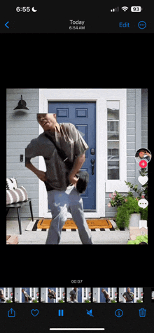 a phone screen shows a video of a man dancing