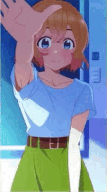 a girl in a blue shirt and green skirt is reaching out her hand .