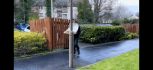 a man carrying a tray of food is walking down a sidewalk