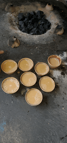 several cups of tea are lined up on a table