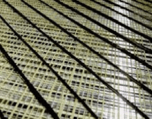 a close up of a wicker mat with a pattern of lines and squares .