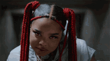 a close up of a woman with red braids