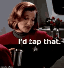 a woman in a star trek uniform is holding a cup and saying `` i 'd zap that '' .