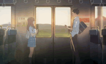 a boy and a girl are standing next to each other on a subway