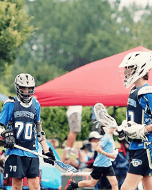 a lacrosse player wearing a jersey with the number 70 on it