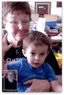 a woman is holding a young boy who is wearing a shirt that says guatemala