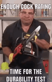 a man is holding a chainsaw in his hands in a workshop .