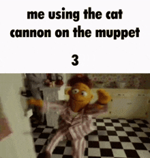 a muppet is sitting on a checkered floor in a kitchen and using the cat cannon on the muppet show .