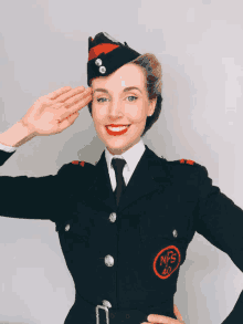 a woman in a military uniform salutes with the letters nfs 40 on her sleeve