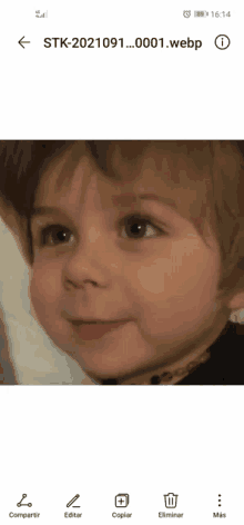 a child 's face is displayed on a phone screen