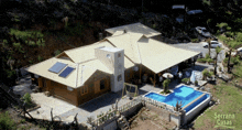 an aerial view of a house with a pool and the words serrana casas