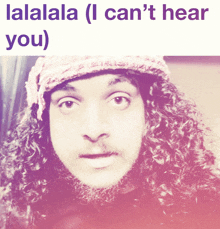 a picture of a man with curly hair and a hat with the words lalala ( i can 't hear you )