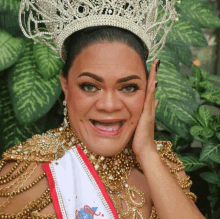 a woman wearing a crown and a sash that says ' ss ' on it