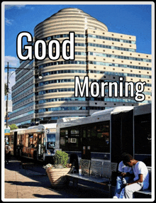 a man sits on a bench in front of a large building with the words good morning on it