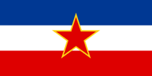 a red white and blue flag with a red star in the middle