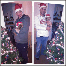 a man wearing a santa hat holds a small dog