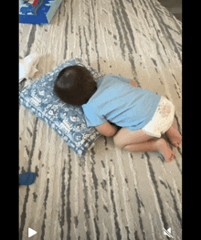 a baby in a diaper is laying on a bed with a pillow that says disney on it