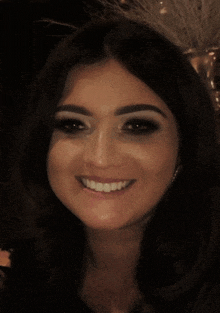 a close up of a woman 's face smiling