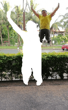 a silhouette of a person jumping in the air with their arms outstretched