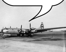 a black and white photo of a single engine plane with a speech bubble above it