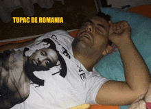 a man wearing a tupac de romania t-shirt is sleeping