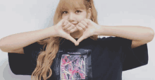 a woman making a heart shape with her hands