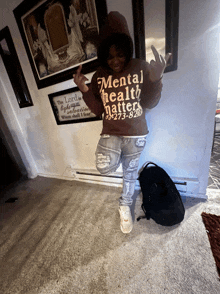 a person wearing a brown mental health matters hoodie