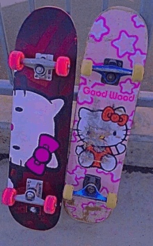 two hello kitty skateboards are sitting next to each other on the ground