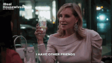 a woman is holding a glass of water and saying i have other friends