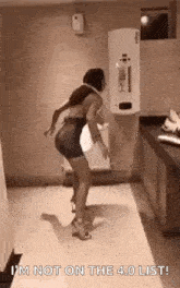 a woman is dancing in a bathroom with the words `` i 'm not on the 4.0 list '' written on the floor .