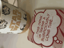 a star wars mug is next to a coaster that says this drink is taking a suspiciously long time