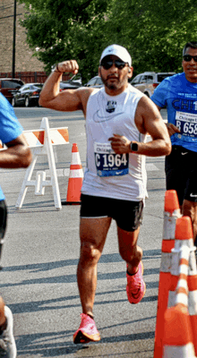 a man running a marathon with the number c 1964 on his shirt