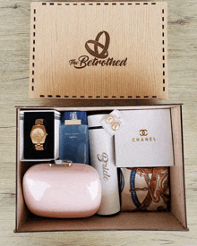 a wooden box with a watch and a bottle of dolce & gabbana light blue