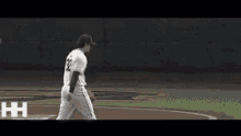 a baseball player with the number 21 on his jersey walks on the field