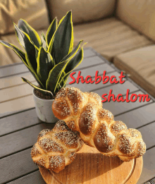 a sign that says shabbat shalom on it next to some bread