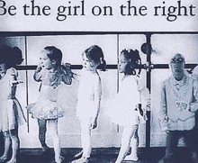 a group of young girls are standing next to each other in front of a sign that says `` be the girl on the right ''