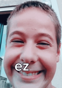 a close up of a child 's face with the word ez on his mouth