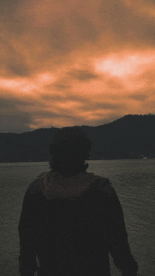 a person standing in front of a body of water