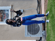 a woman taking a picture of herself in front of a window