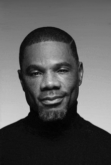 a black and white photo of a man with a beard and freckles