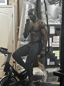 a man is taking a picture of himself while riding a voyager exercise bike