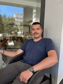 a man wearing a watch sitting in a chair