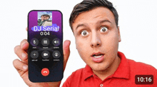 a man in a red shirt is holding a phone that says dj serial on the screen