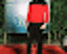 a blurry picture of a person wearing a red shirt and black pants