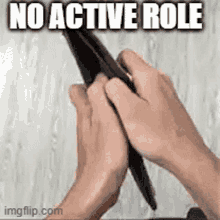 a person is holding a pen in their hands with the words `` no active role '' written on the bottom .