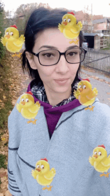 a woman wearing glasses is surrounded by cartoon chickens on her face