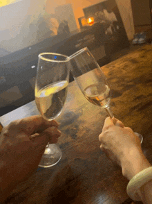 two glasses of wine on a wooden table